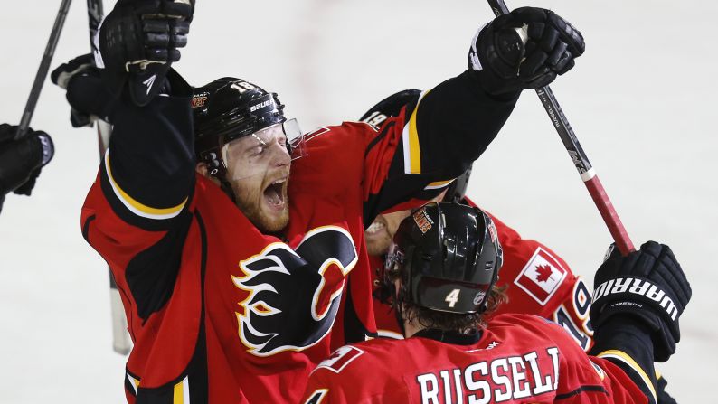 Matt Stajan celebrates his a goal with teammates Kris Russell and David Jones on Saturday, April 25 on Calgary, Canada, during the Stanley Cup Playoffs. The Calgary Flames won against the Vancouver Canucks 7-4, taking them to the next round. <br />