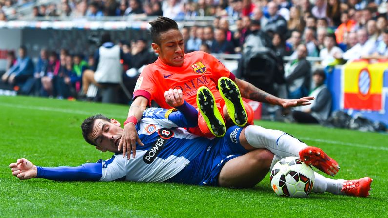 Neymar da Silva Santos Júnior of FC Barcelona is brought down by Anaitz Arbilla of RCD Espanyol during a match on Saturday, April 25, in Barcelona, Spain. FC Barcelona won 2-0.