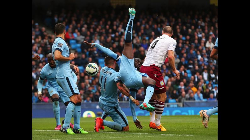 Yaya Toure of Manchester City tangles for the ball with teammate Aleksandar Kolarov and Ron Vlaar of Aston Villa on Saturday, April 25, in Manchester.