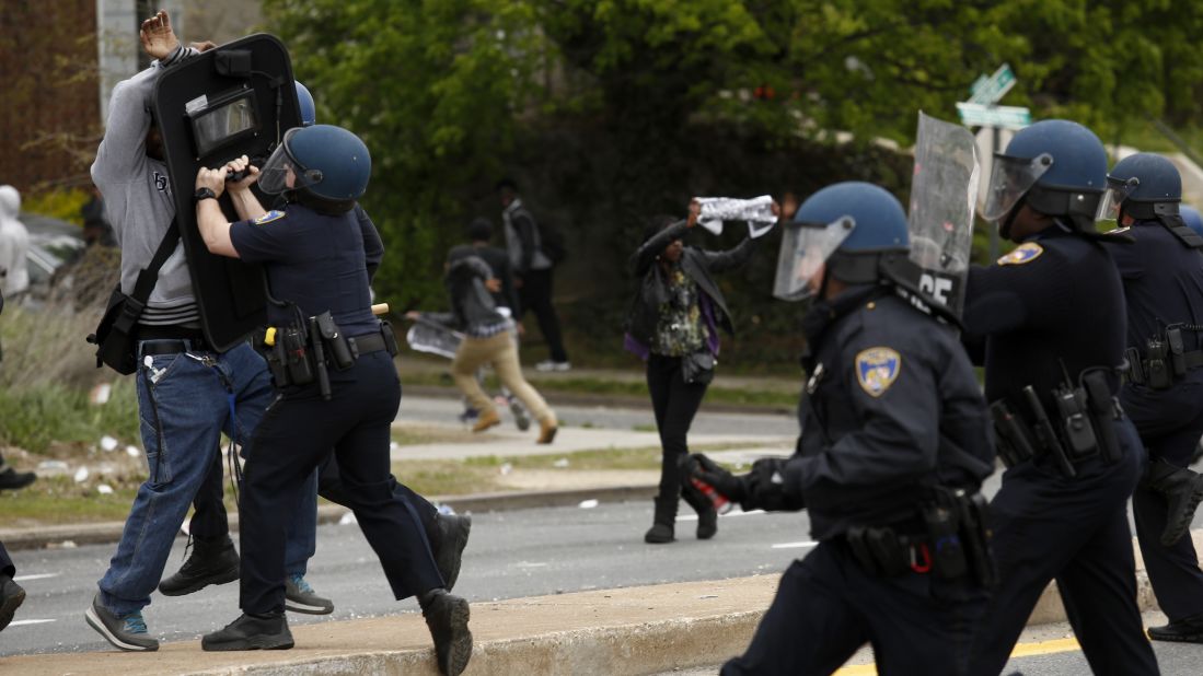 Police officers push back a protester on April 27.