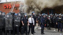 BALTIMORE, MD - APRIL 27: Baltimore Police form a parimeter around a CVS pharmacy that was looted and burned near the corner of Pennsylvania and North avenues during violent protests following the funeral of Freddie Gray April 27, 2015 in Baltimore, Maryland. Gray, 25, who was arrested for possessing a switch blade knife April 12 outside the Gilmor Homes housing project on Baltimore's west side. According to his attorney, Gray died a week later in the hospital from a severe spinal cord injury he received while in police custody.  (Photo by Chip Somodevilla/Getty Images)