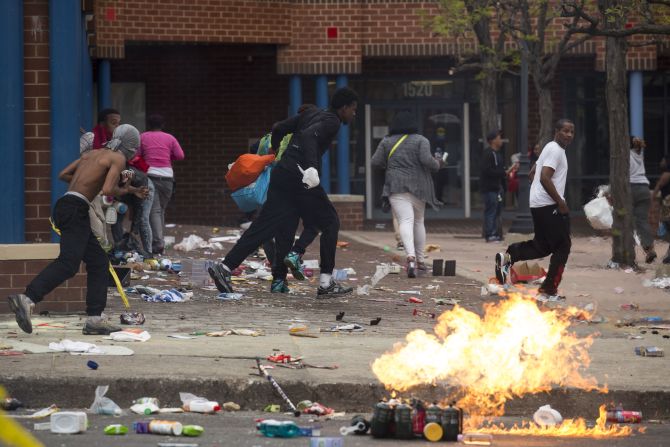 People carrying goods leave a CVS pharmacy near Pennsylvania and North avenues on April 27.