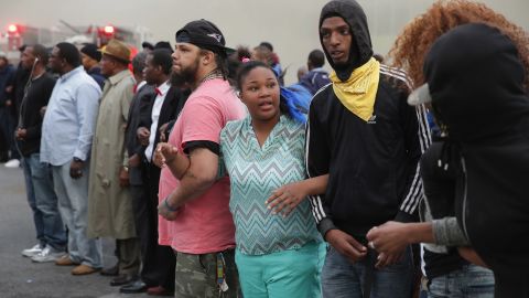 People lock arms and form a line opposing police at the corner of Pennsylvania and North avenues on April 27.