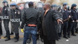 BALTIMORE, MD - APRIL 27:  A man attempts to calm a fellow demonstrator as they face off with Baltimore Police at the corner of Pennsylvania and North avenues during violent protests following the funeral of Freddie Gray April 27, 2015 in Baltimore, Maryland. Gray, 25, who was arrested for possessing a switch blade knife April 12 outside the Gilmor Homes housing project on Baltimore's west side. According to his attorney, Gray died a week later in the hospital from a severe spinal cord injury he received while in police custody.  (Photo by Chip Somodevilla/Getty Images)