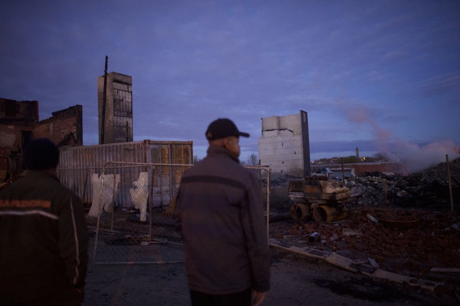 The remains of a senior center smolder on April 28. Riots broke out Monday, April 27, after<a href="http://www.cnn.com/2015/04/27/us/gallery/freddie-gray-funeral/index.html"> Freddie Gray's funeral</a>.