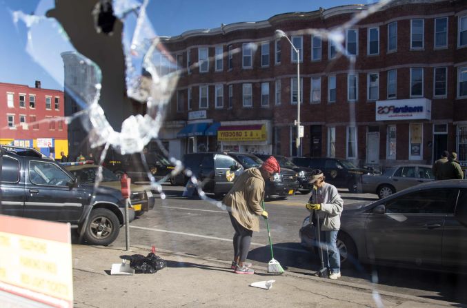 Two women sweep up the streets in Baltimore -- reflected in the broken window of a storefront on April 28. <a href="index.php?page=&url=http%3A%2F%2Fwww.cnn.com%2F2015%2F04%2F29%2Fus%2Fgallery%2Fbaltimore-protests-cleanup%2Findex.html">See more photos of the cleanup efforts.</a>