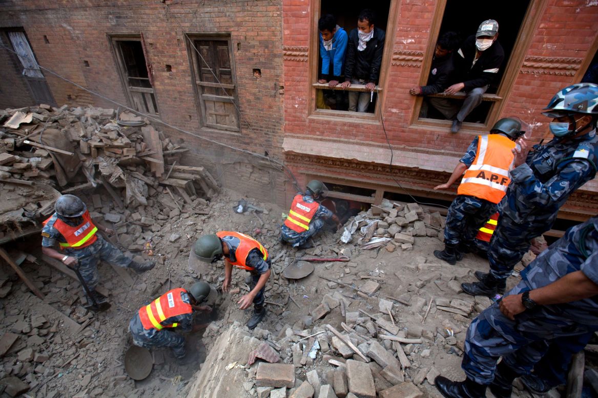 Nepalese military police search through rubble outside Kathmandu on April 28.