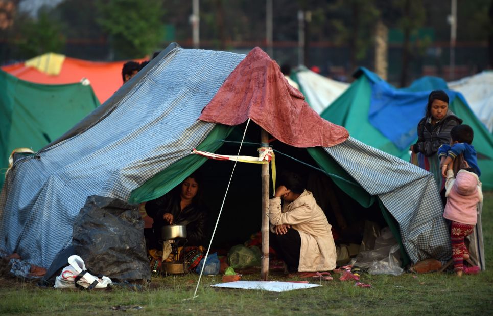 People rest April 28 in a temporary housing camp in Kathmandu. Large encampments of tents have sprung up in open areas, including a wide space belonging to the military in the center of the capital.