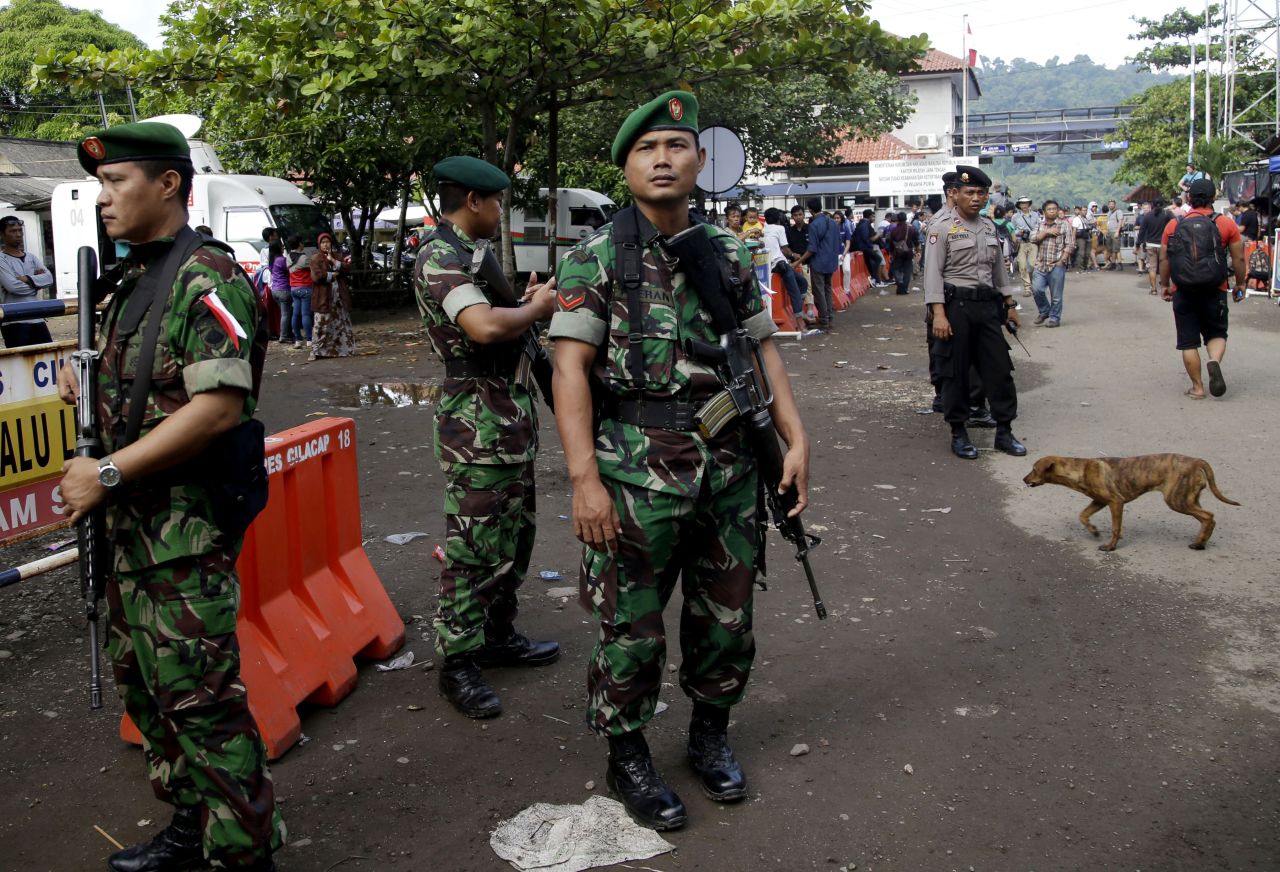 Indonesian soldiers and police officers stand guard at the Wijayapura ferry port in Cilacap on April 28. 