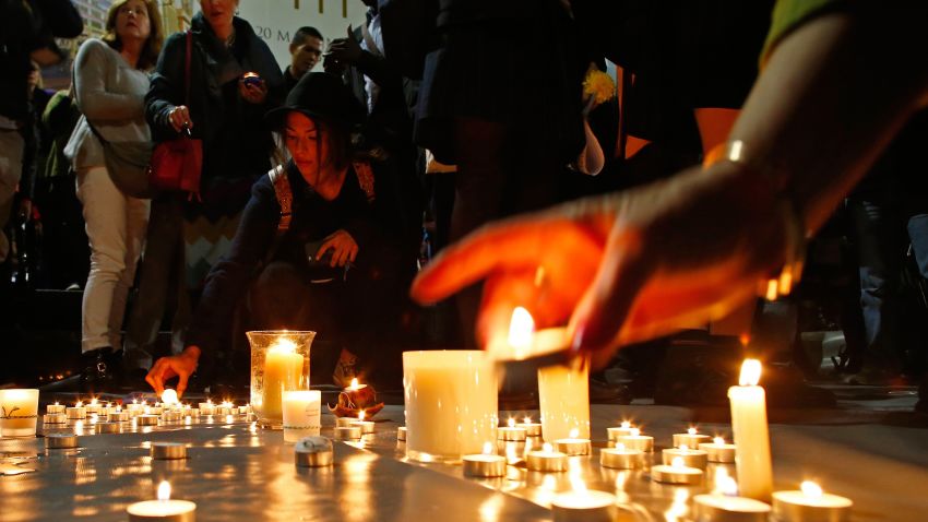 SYDNEY, AUSTRALIA - APRIL 28: A woman lits a candle for the prisoners to be executed in Indonesia, during a vigil at Martin Place on April 28, 2015 in Sydney, Australia. Supporters of Bali Nine duo Andrew Chan and Myuran Sukumaran held a vigil tonight as the pair prepare to face the firing squad this evening at Indonesia's Nusakambangan Island. Chan and Sukumaran were both sentenced to death after being found guilty of attempting to smuggle 8.3kg of heroin valued at around $4 million from Indonesia to Australia along with 7 other accomplices. (Photo by Daniel Munoz/Getty Images)