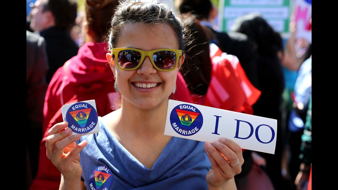 McKenna Inskeep hands out stickers in support of marriage equality outside the Supreme Court.