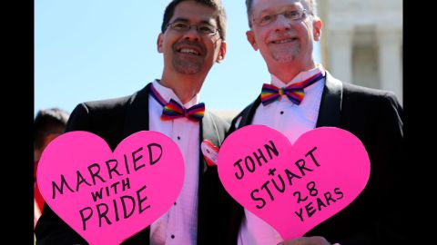 Outside the Supreme Court, John Lewis and Stuart Gaffney of San Francisco hold signs celebrating their marriage.