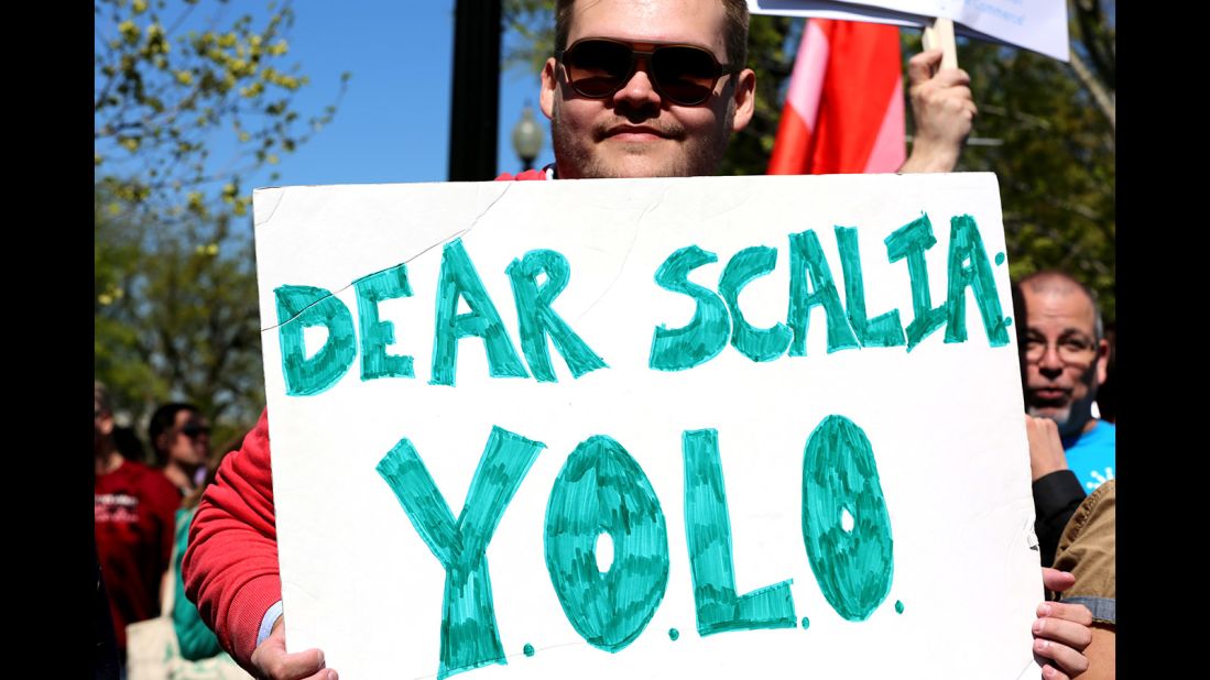 Andrew Damron of Brooklyn, New York, holds up a sign with the motto "You Only Live Once" in support of same-sex marriage. 