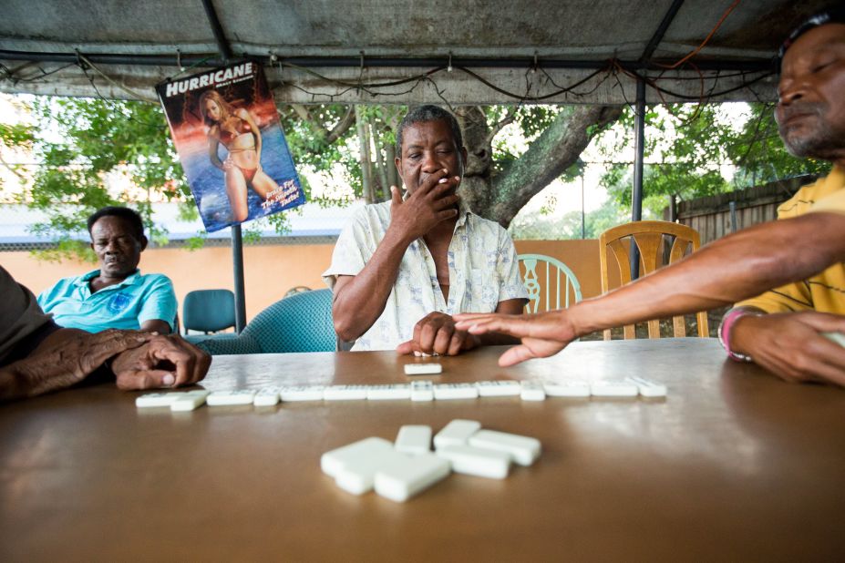 Members of Miami's enormous Afro-Caribbean community enjoy a game of dominoes outside.