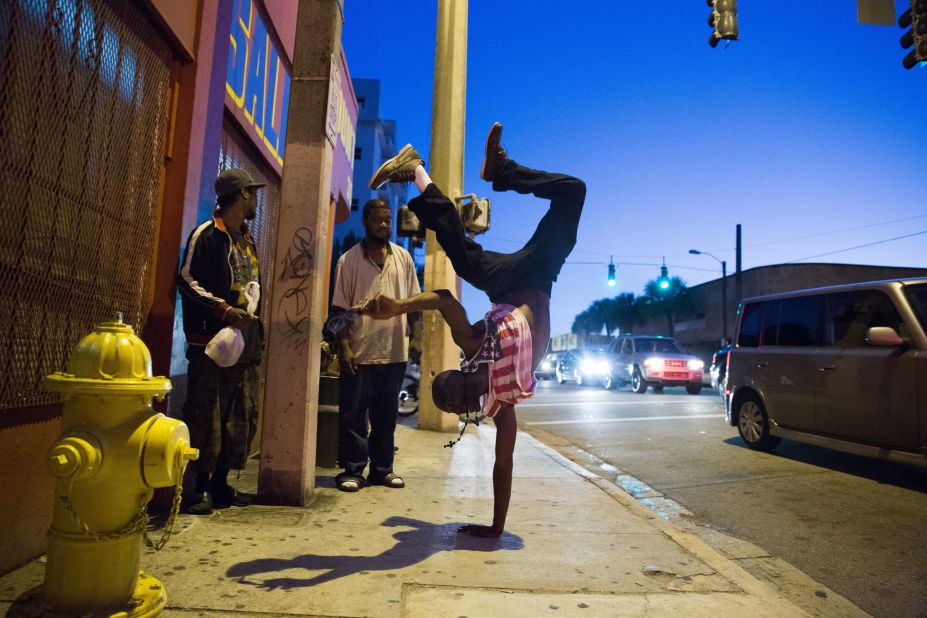 A resident of Miami break dances in the street.
