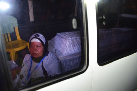 A coffin bearing the body of one of the executed is transported in an ambulance escorted by an unidentified woman on April 29. 