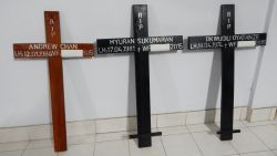 Crosses for condemned drug convicts (from L-R) Australians Andrew Chan (L) and Myuran Sukumaran (C), and Nigerian Okwudili Oyatanze are seen following their completion at a church in Cilacap on April 28, 2015, ahead of convicts' imminent execution at the Nusakambangan maximum security prison island. Indonesia made final preparations April 28 to execute eight foreigners by firing squad, as family members wailed in grief during last visits to their loved ones and ambulances carrying white coffins arrived at the drug convicts' prison. AFP PHOTO / AZKA (Photo credit should read AZKA/AFP/Getty Images)