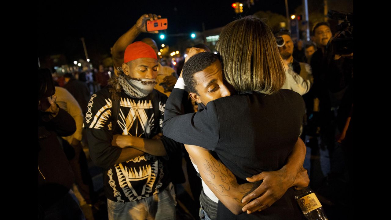 State Sen. Catherine E. Pugh embraces a protestor while urging the crowd to disperse ahead of a 10 p.m. curfew in Baltimore on Tuesday, April 28.