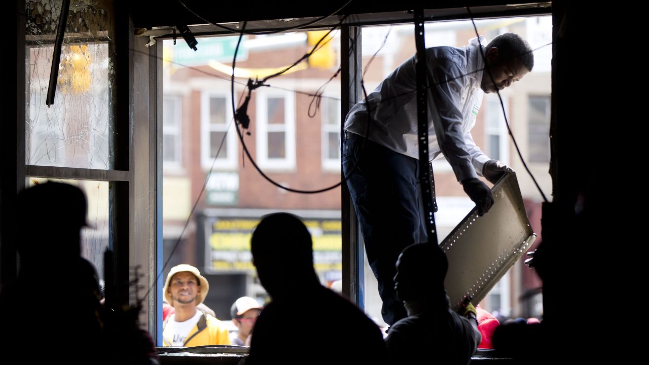 Volunteers help clear the wreckage from damaged stores on April 28.