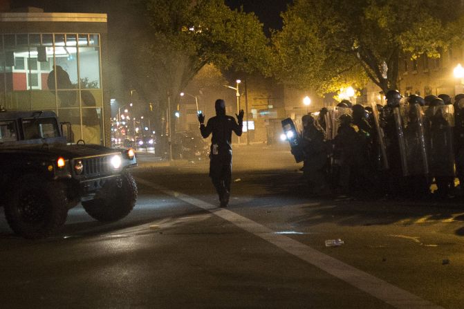 A community organizer later identified as Joseph Kent paces in front of riot police with his hands up during a curfew in Baltimore on Tuesday, April 28. Moments later, he was seen being <a href="index.php?page=&url=http%3A%2F%2Fwww.cnn.com%2Fvideos%2Fus%2F2015%2F04%2F29%2Fctn-live-cuomo-baltimore-joseph-kent-arrested.cnn">arrested by police live on CNN</a>. Kent's lawyer said on April 30 that his client had been released from jail. While some protesters defied the curfew and faced off with police, demonstrations Tuesday were largely peaceful. 
