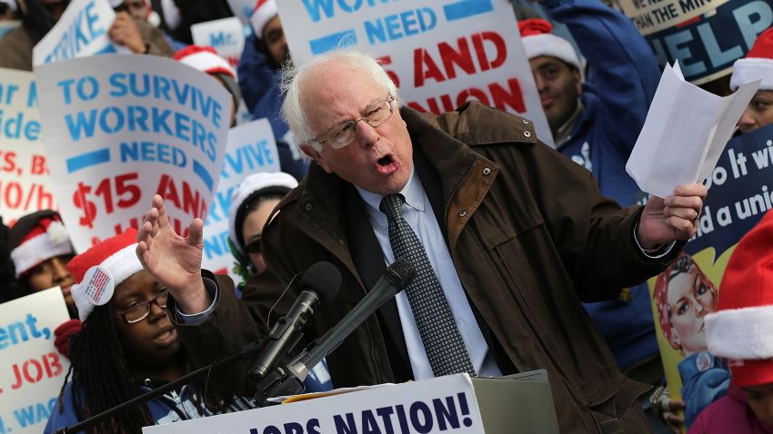 Sanders speaks to low-wage federal contract workers during a protest where the workers demanded presidential action to win an increase to $15 an hour wage on December 4, 2014, in Washington, D.C.