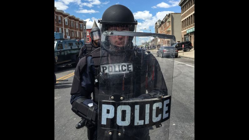 At around noon, Larson took portraits of police officers in full riot gear, forming a line blocking North Avenue. "We watched the police mass, from a few officers when we arrived to one hundred-plus over the span of an hour," he said.