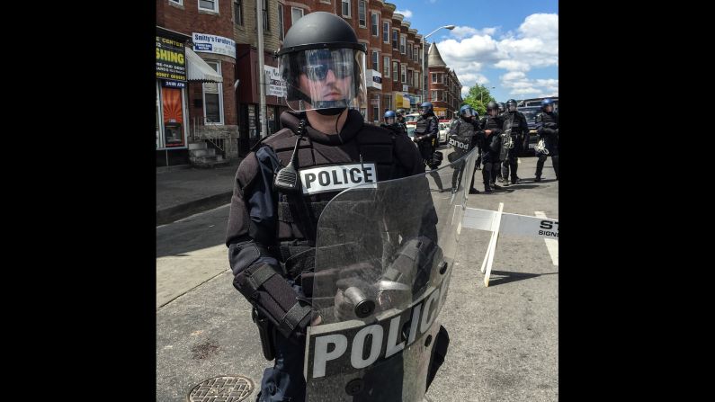 Larson calls the collection of individual police photos "A Portrait of 27 Police Officers, as Positioned, South to North, April 28, 2015."