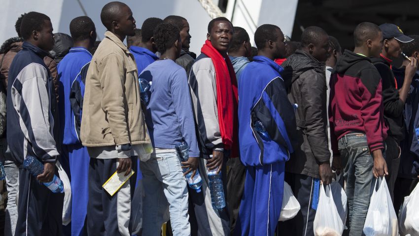 Migrant men wait to board a ship bound for Sicily on April 22, 2015 in Lampedusa, Italy.