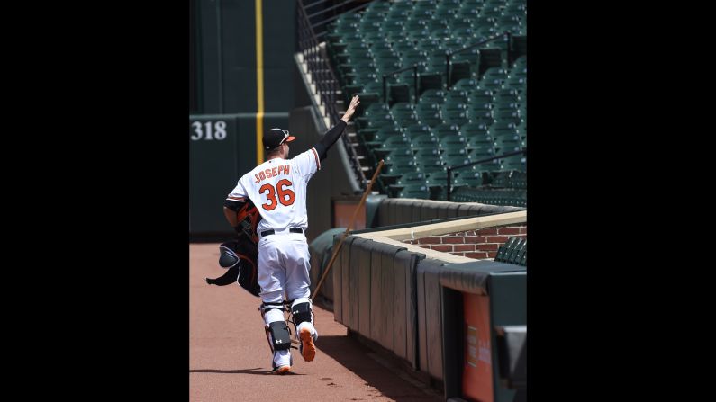 Orioles catcher Caleb Joseph pretends to wave to fans.