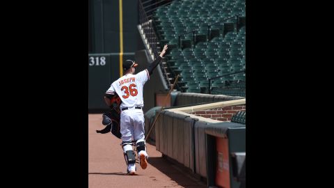 Orioles catcher Caleb Joseph pretends to wave to fans. 