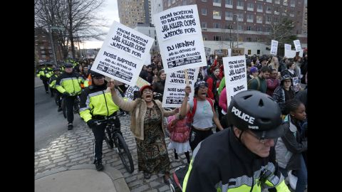 Demonstrators march with a police escort near Boston police headquarters on April 29.