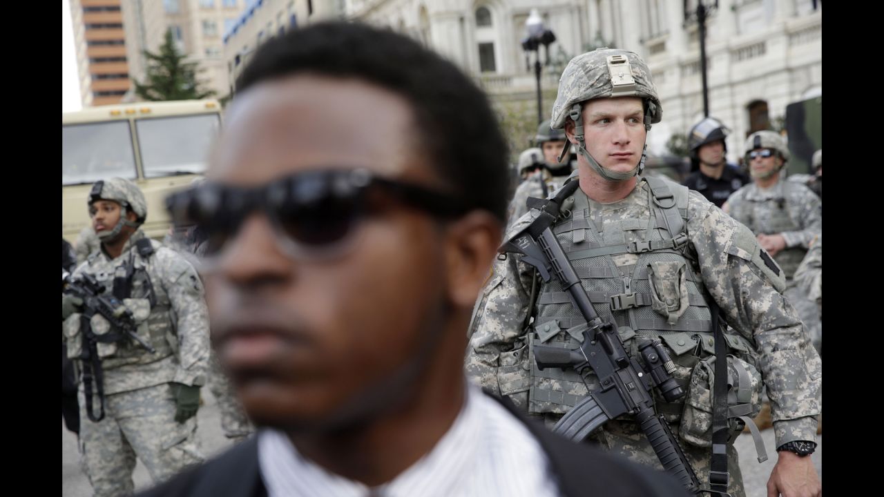 A member of the National Guard stands outside Baltimore City Hall as protesters gather on Wednesday, April 29.