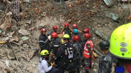 Hero Rescuer Kathmandu Nepal. Rescuers go down into the site where an 18-year-old was rescued Thursday.