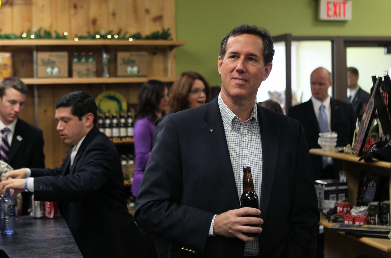 Santorum tries one of the local craft beers while having lunch at Simon's Specialty Cheese following a campaign stop in Appleton, Wisconsin, on April 2, 2012.