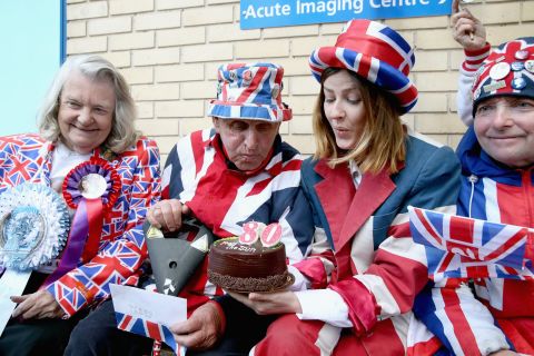 APRIL 30 -- LONDON: Royalist Terry Hutt blows out the candles on a cake on his 80th birthday as he waits for a new royal baby at the Lindo wing of St Mary's Hospital.