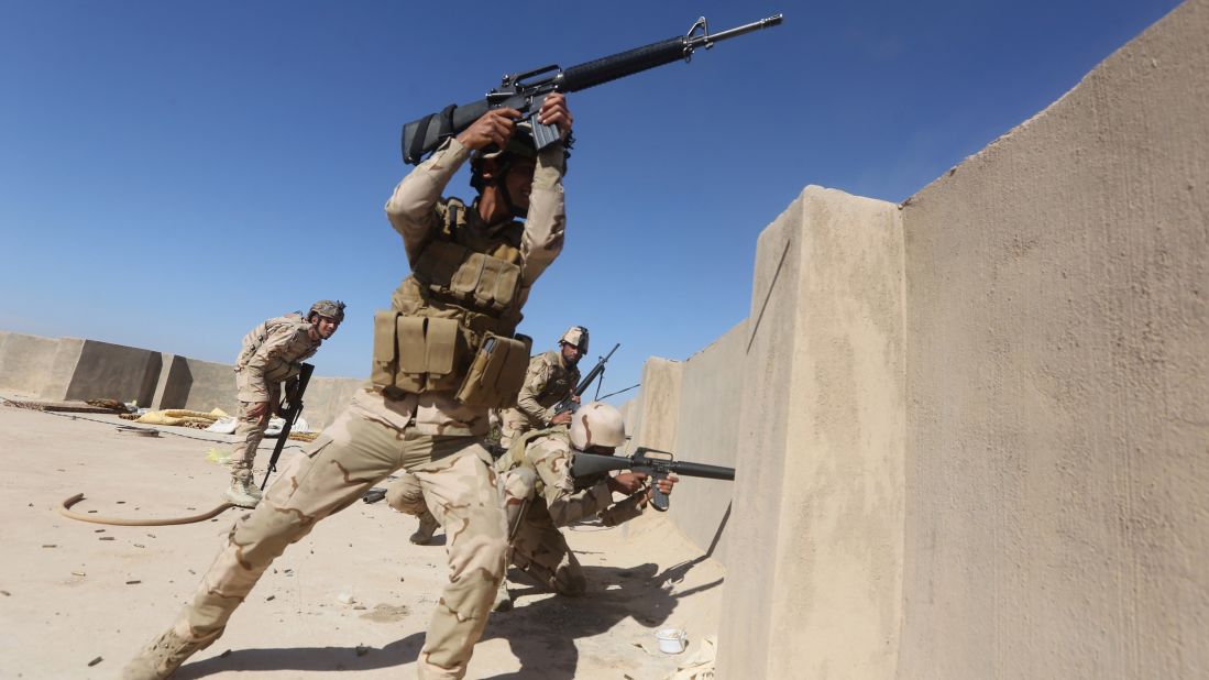 Iraqi soldiers fire their weapons toward ISIS group positions in the Garma district, west of the Iraqi capital of Baghdad, on Sunday, April 26. Pro-government forces said they had recently made advances on areas held by Islamist jihadists.