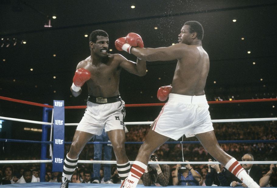 Michael Spinks, left, blocks a punch from Larry Holmes at a heavyweight title fight on September 21, 1985, at the Riviera. Spinks won the fight by a unanimous decision in the 15th round.