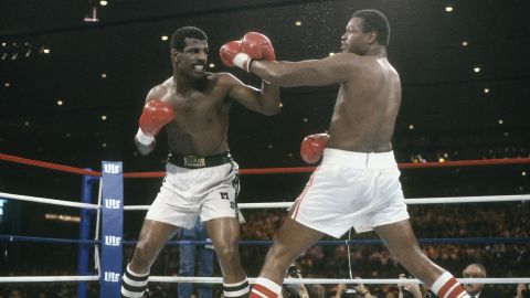 Michael Spinks blocks a punch from Larry Holmes, right, in 1985. Holmes' comments on race would make a connection. 