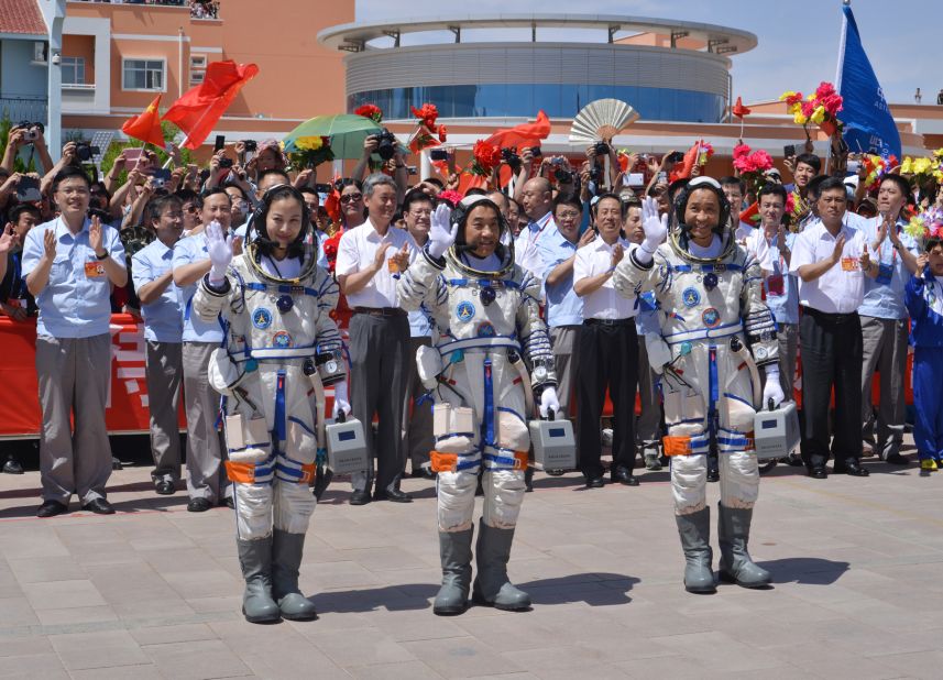 Nie, Zhang  and Wang wave to onlookers the day before the start of the mission. <br /><br /> 