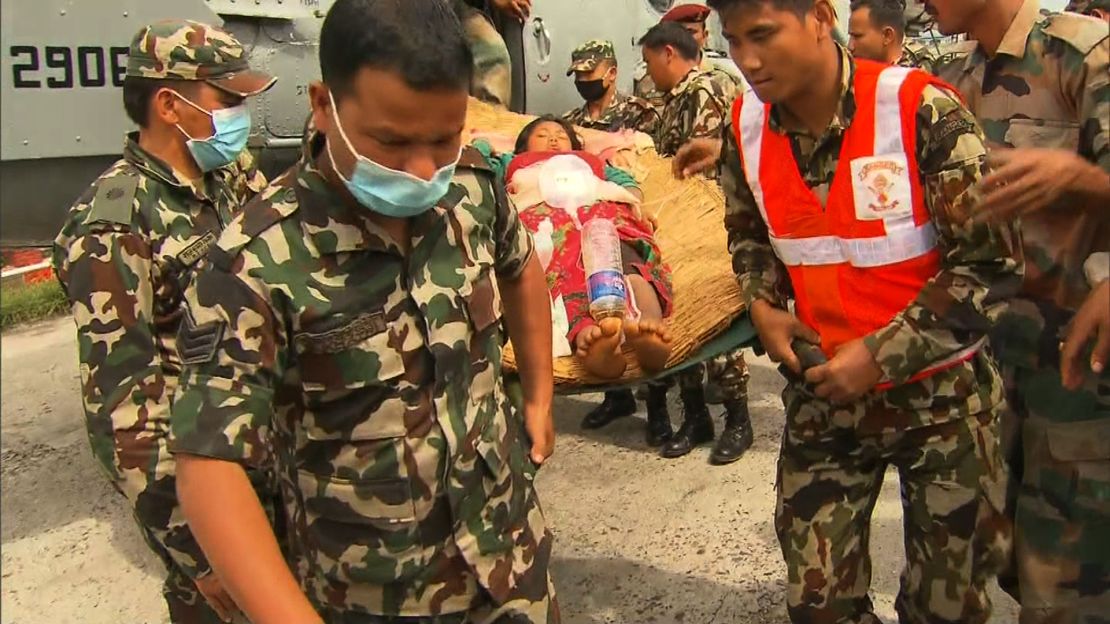 Soldiers carry Sabina on a makeshift straw stretcher in Kathmandu, April 30, 2015.