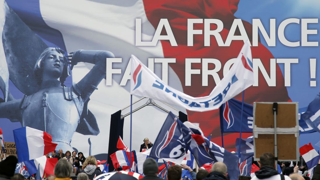 France's far-right National Front leader Marine Le Pen, center, delivers a speech during the May Day march in Paris.
