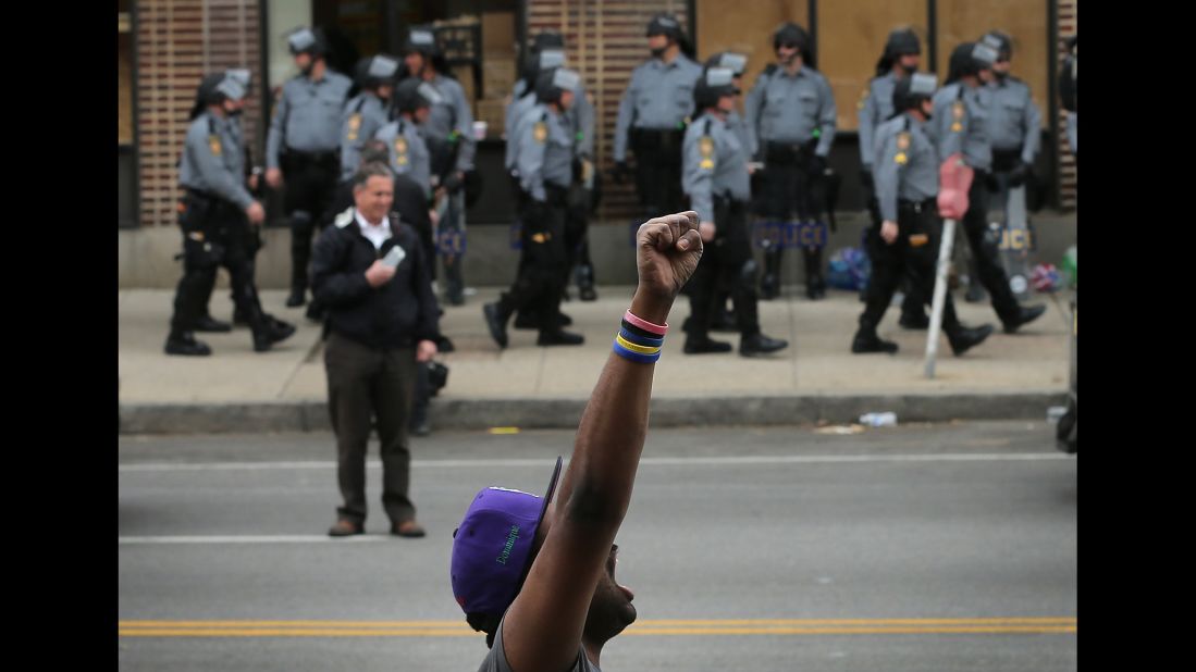 A demonstrator celebrates in Baltimore the charges were announced on May 1.