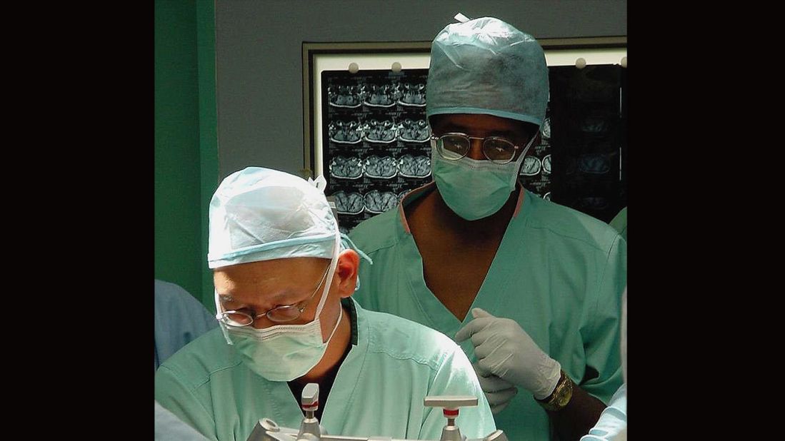 Carson observes the start of neurosurgery proceedings at the Raffles Hospital in Singapore on July 6, 2003. Carson and Dr. Keith Goh, left, performed a complex operation that was unsuccessful to separate 29-year-old twins Ladan And Laleh Bijani, who were joined at the head.