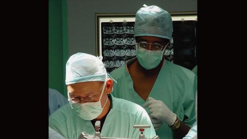 Carson observes the start of neurosurgery proceedings at the Raffles Hospital in Singapore on July 6, 2003. Carson and Dr. Keith Goh, left, performed a complex operation that was unsuccessful to separate 29-year-old twins Ladan And Laleh Bijani, who were joined at the head.