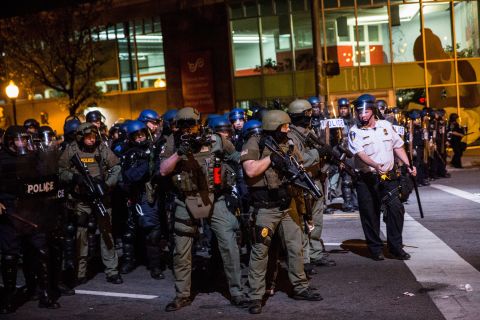 Police in riot gear enforce a 10 p.m. curfew and clear Baltimore streets of protesters and media on Friday, May 1.