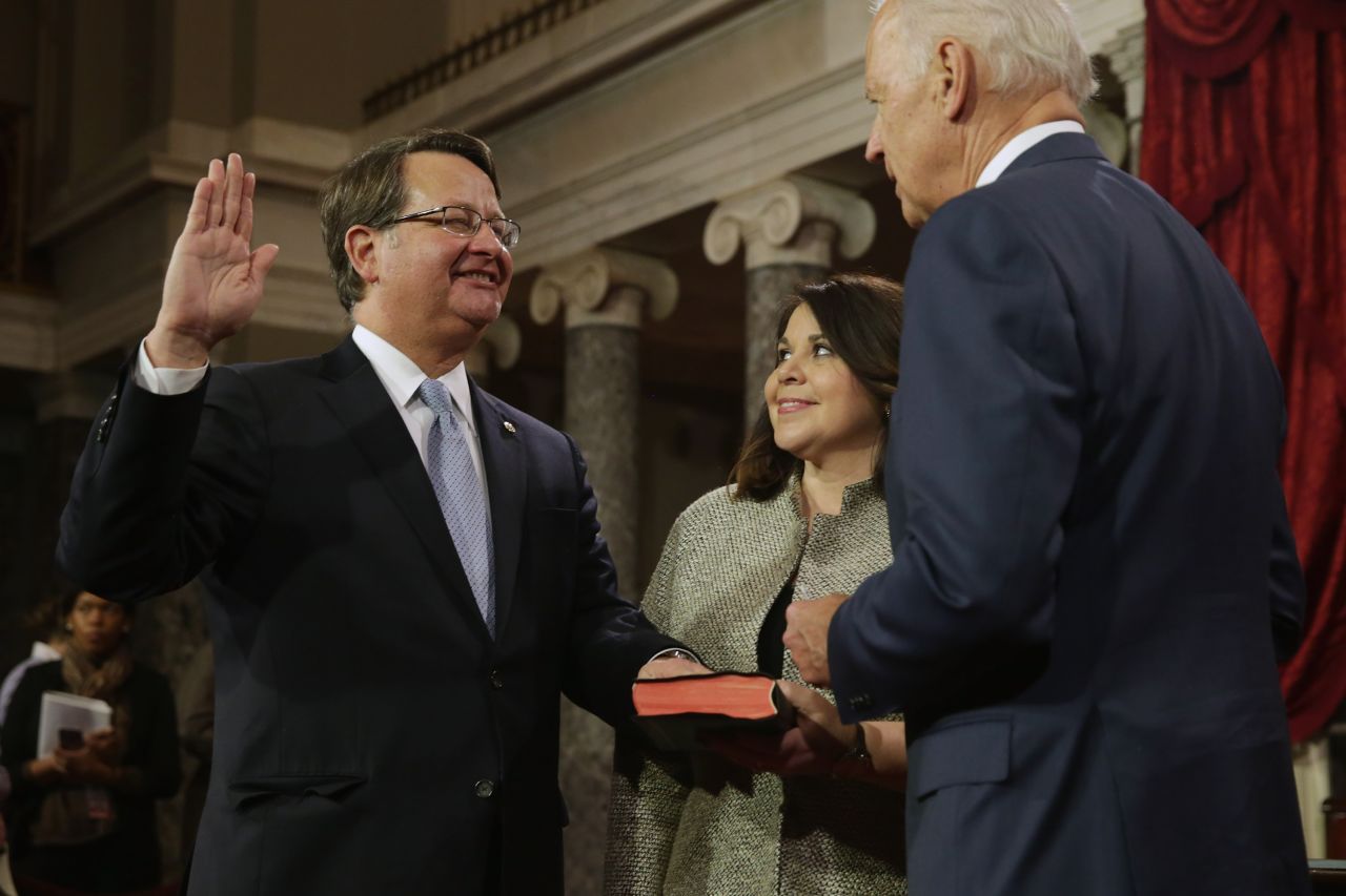 Democrats point to Michigan Sen. Gary Peters' strategy with attacking the Koch brothers as an example of one that works. When he ran in the last election, his campaign criticized the Kochs' political spending and accused one of their companies of creating pollution in Michigan. He won the election. Peters is pictured alongside his wife, Colleen Ochoa, as he is sworn in by Vice President Joe Biden at the U.S. Capitol on January 6.