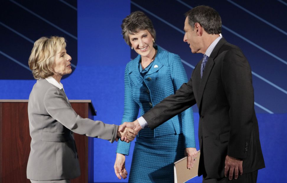 Boxer, left, and Fiorina, center, greet moderator Randy Shandobil, right, after a debate on the campus of Saint Mary's College September 1, 2010, in Moraga, California.