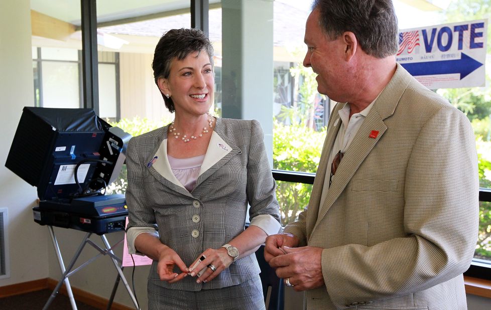 Fiorina, left, smiles with her husband Frank Fiorina, right, after casting their ballots at a polling place June 8, 2010, in Los Altos Hills, California. 