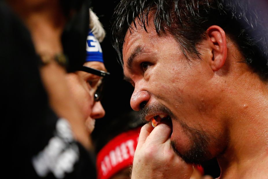 Trainer Freddie Roach adjusts Manny Pacquiao's mouth guard at the MGM Grand Garden Arena in Las Vegas. <br />.