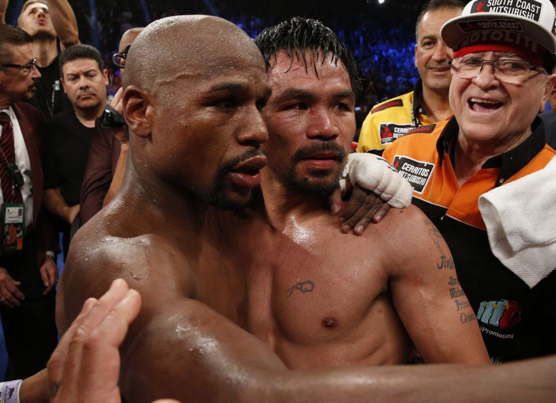 Floyd Mayweather Jr., left, hugs Manny Pacquiao after defeating him in their welterweight unification bout.